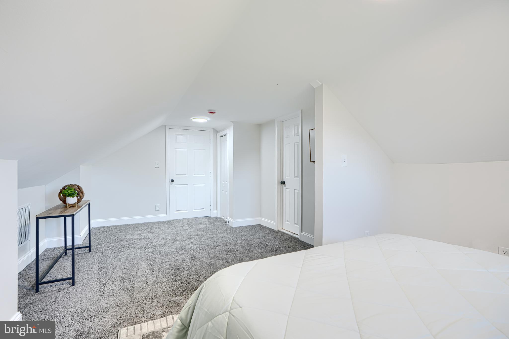 212 North Marlyn Avenue Essex, MD 21221 - Photo 44 of 54 a bedroom with a bed a chair and painting on the wall