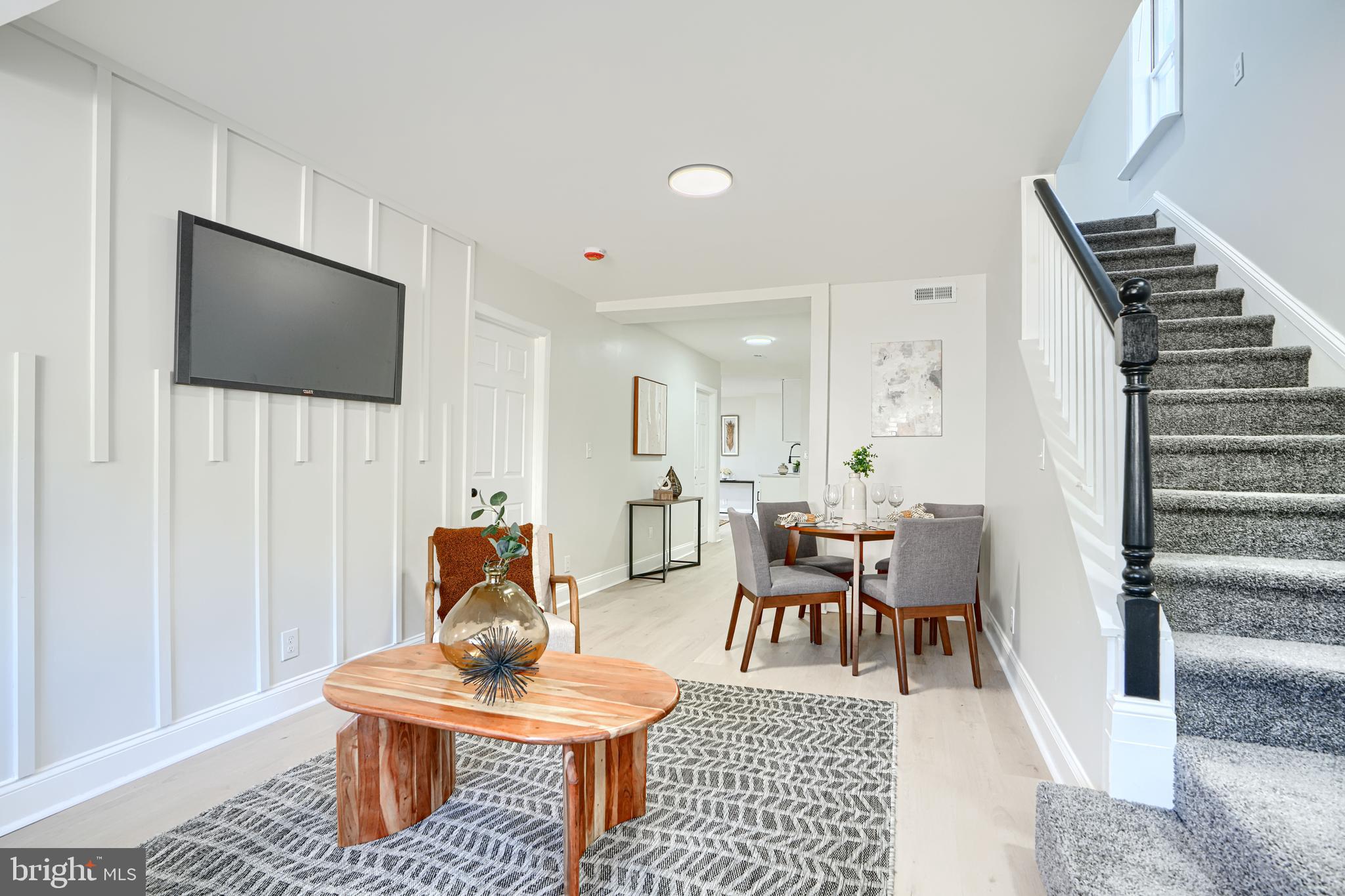212 North Marlyn Avenue Essex, MD 21221 - Photo 8 of 54 a living room with furniture a rug and a flat screen tv