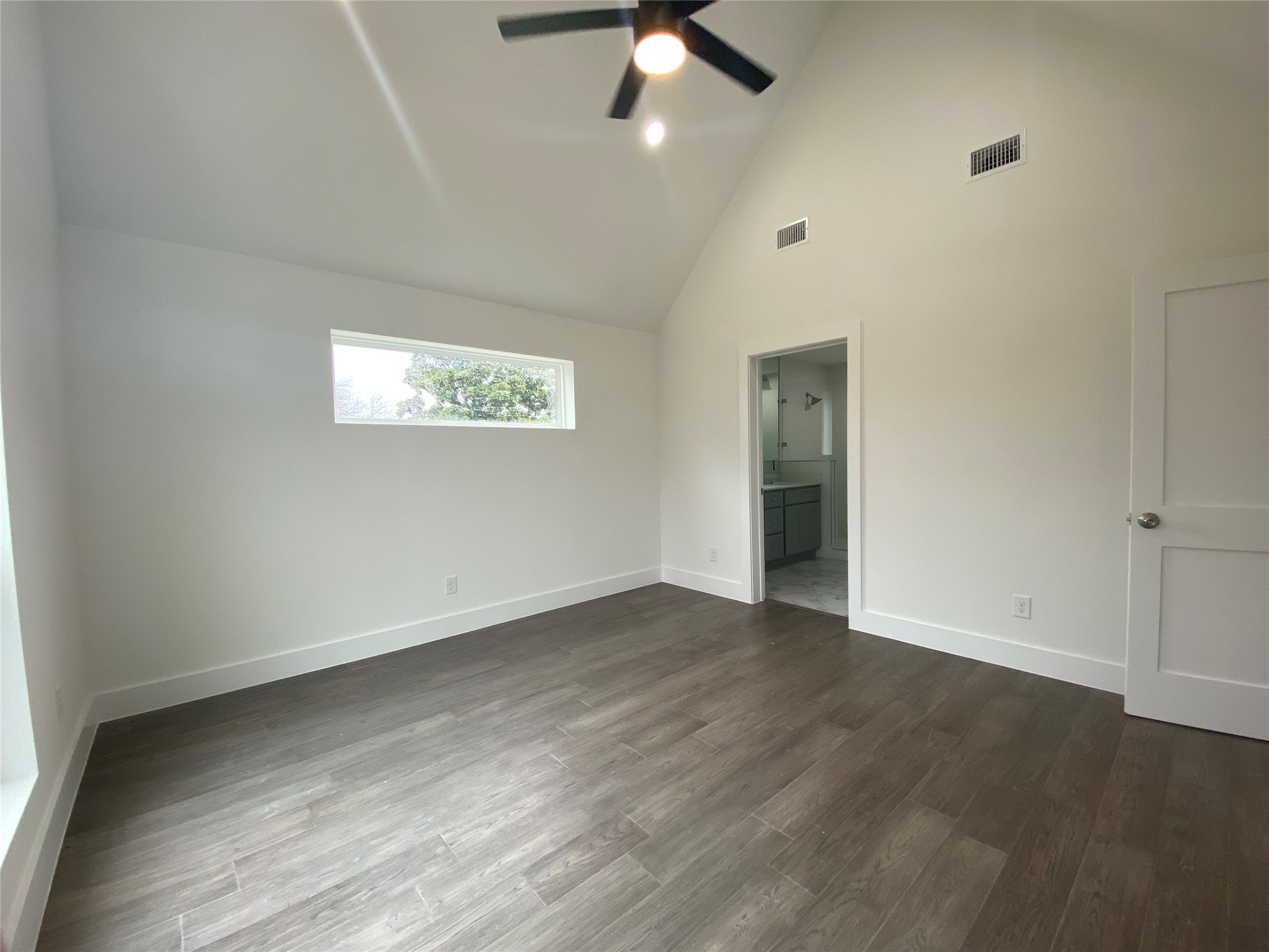 1916 Webberville Road, Unit B Austin, TX 78721 - Photo 16 of 25 Room featuring vaulted ceilings and wood-finish flooring