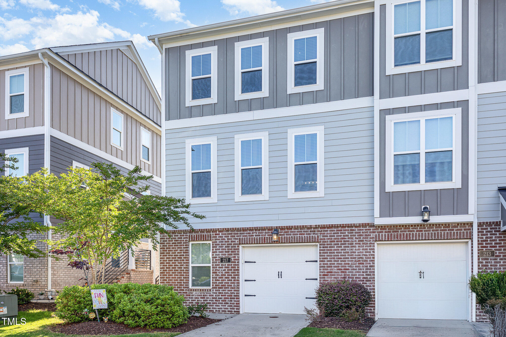 217 Jones Hill Road Holly Springs, NC 27540 - Photo 1 of 39 a front view of a building with a garden