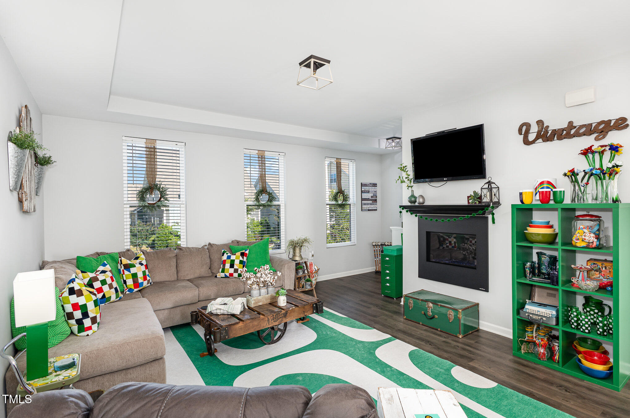 217 Jones Hill Road Holly Springs, NC 27540 - Photo 8 of 39 a living room with furniture a flat screen tv and a fireplace