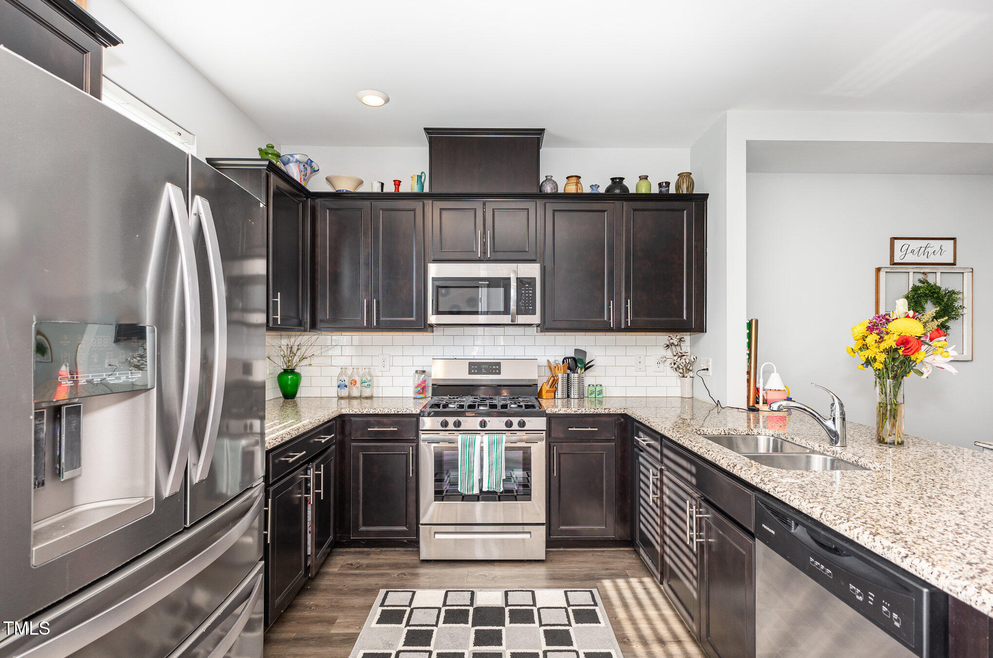 217 Jones Hill Road Holly Springs, NC 27540 - Photo 11 of 39 a kitchen with stainless steel appliances a sink stove and cabinets