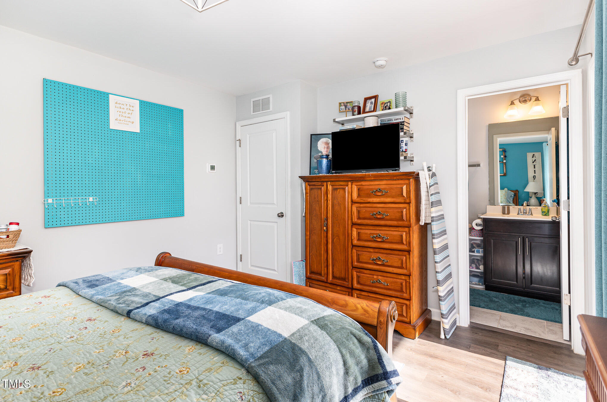 217 Jones Hill Road Holly Springs, NC 27540 - Photo 24 of 39 a bedroom with a bed and a television