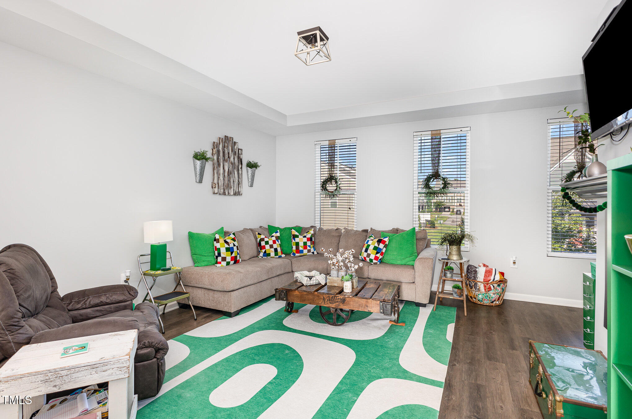 217 Jones Hill Road Holly Springs, NC 27540 - Photo 6 of 39 a living room with furniture and a flat screen tv