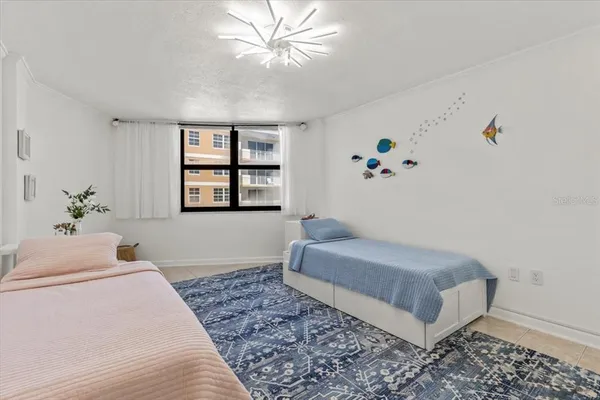 a bedroom with bed and a chandelier