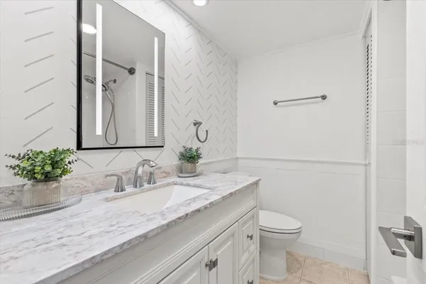 a view of a dining room with furniture and a potted plant