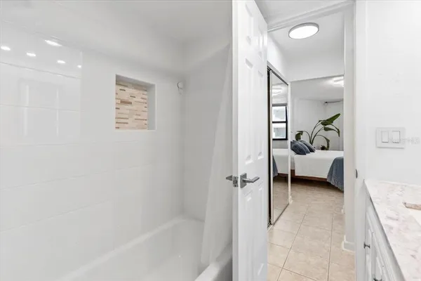 a kitchen with stainless steel appliances kitchen island granite countertop a refrigerator and a sink