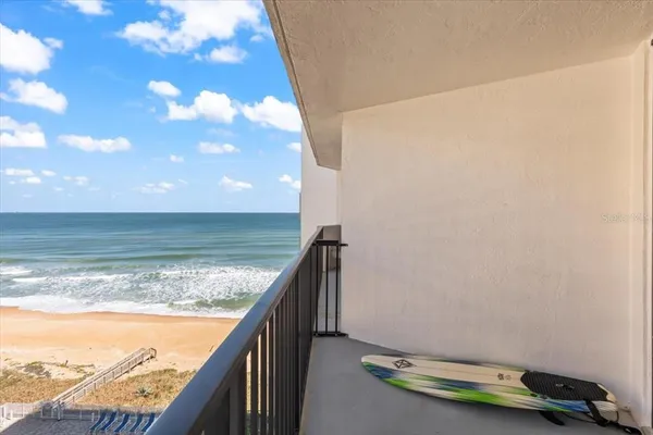 a living room with furniture a flat screen tv and a wooden floor