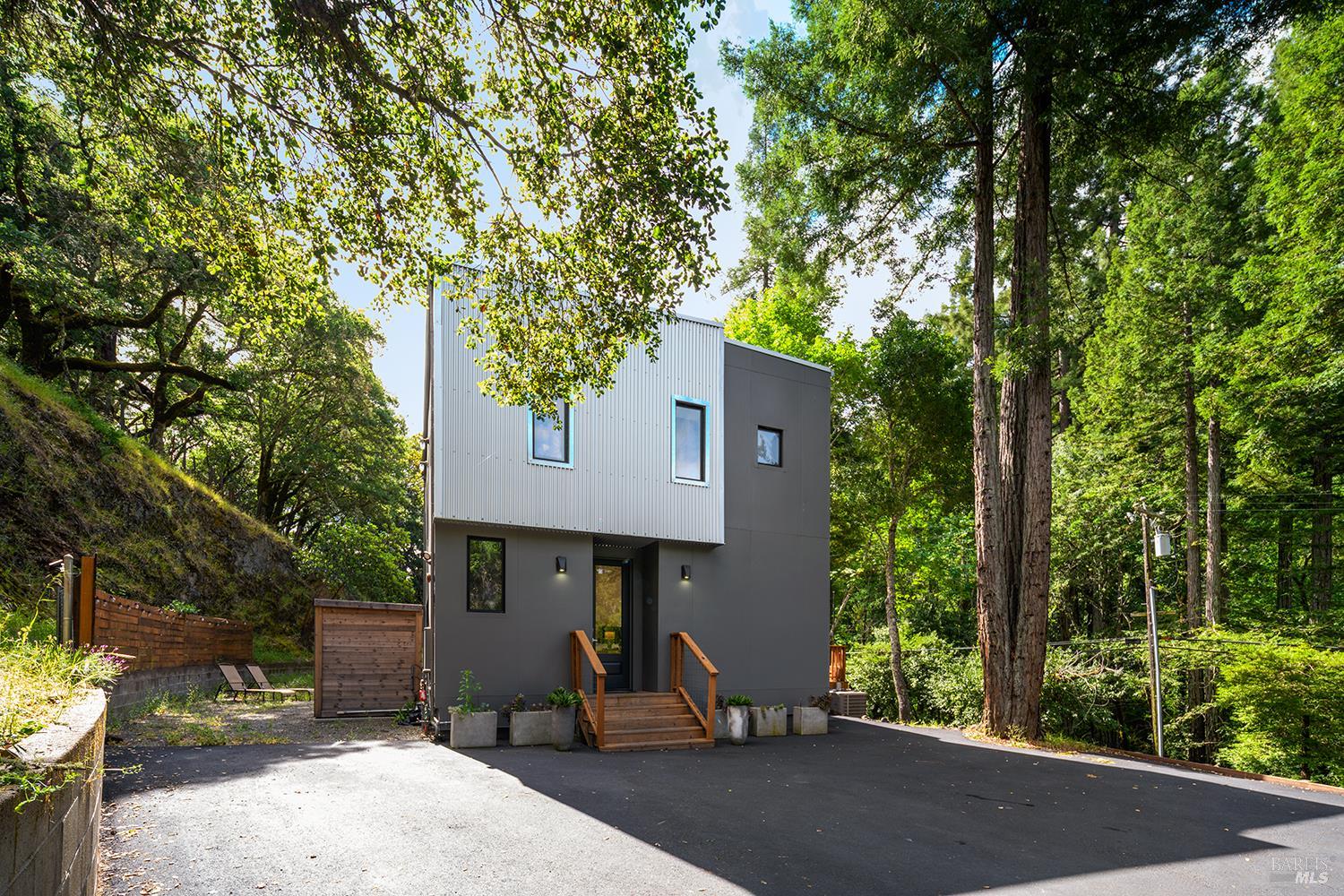 a front view of a house with a yard and sitting area