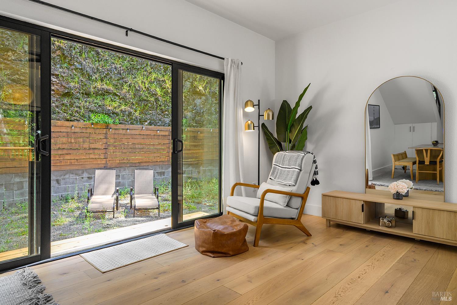2563 Mill Creek Road Healdsburg, CA 95448 - Photo 11 of 42 a living room with furniture and a floor to ceiling window