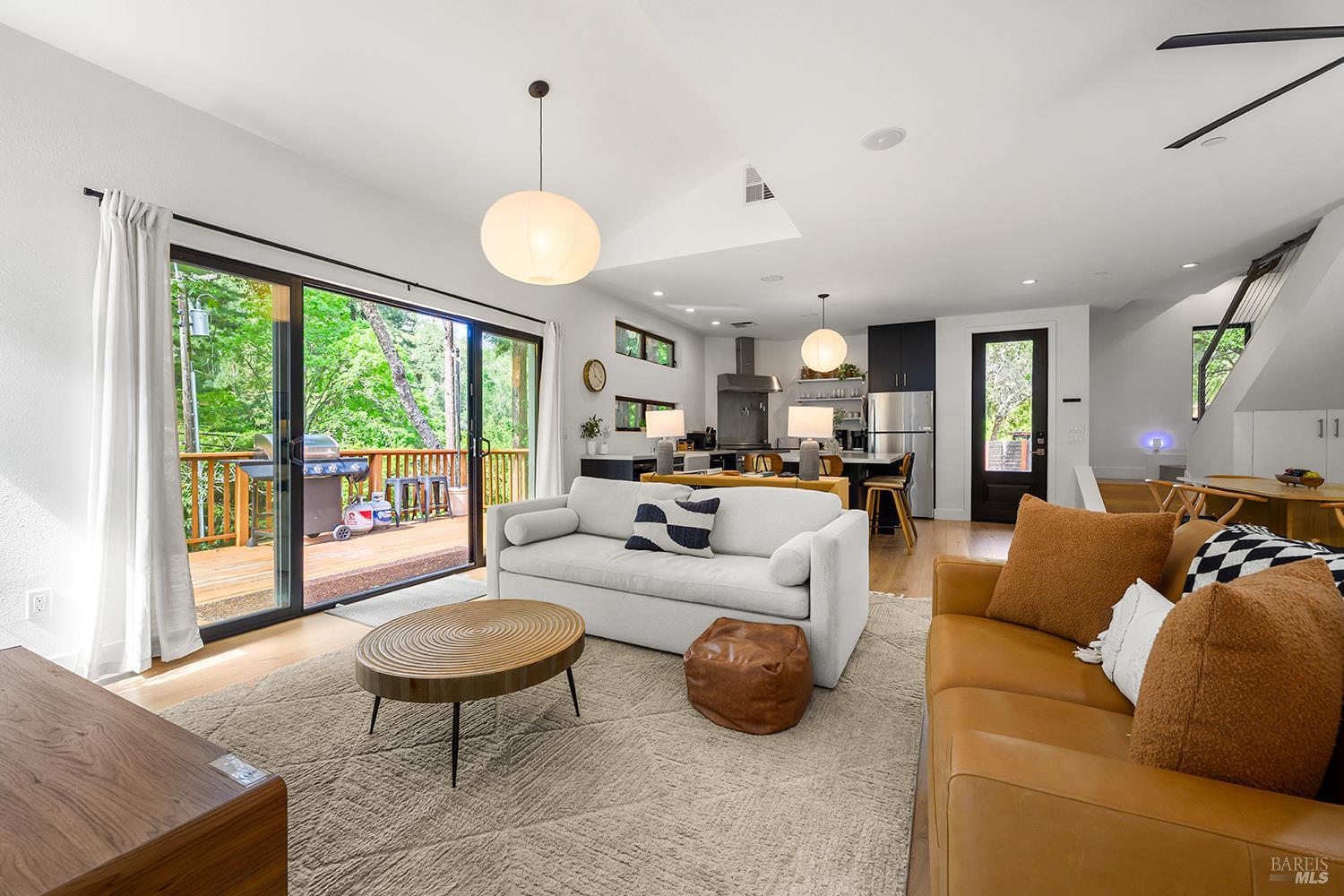 2563 Mill Creek Road Healdsburg, CA 95448 - Photo 13 of 42 a living room with furniture a dining table and a large window