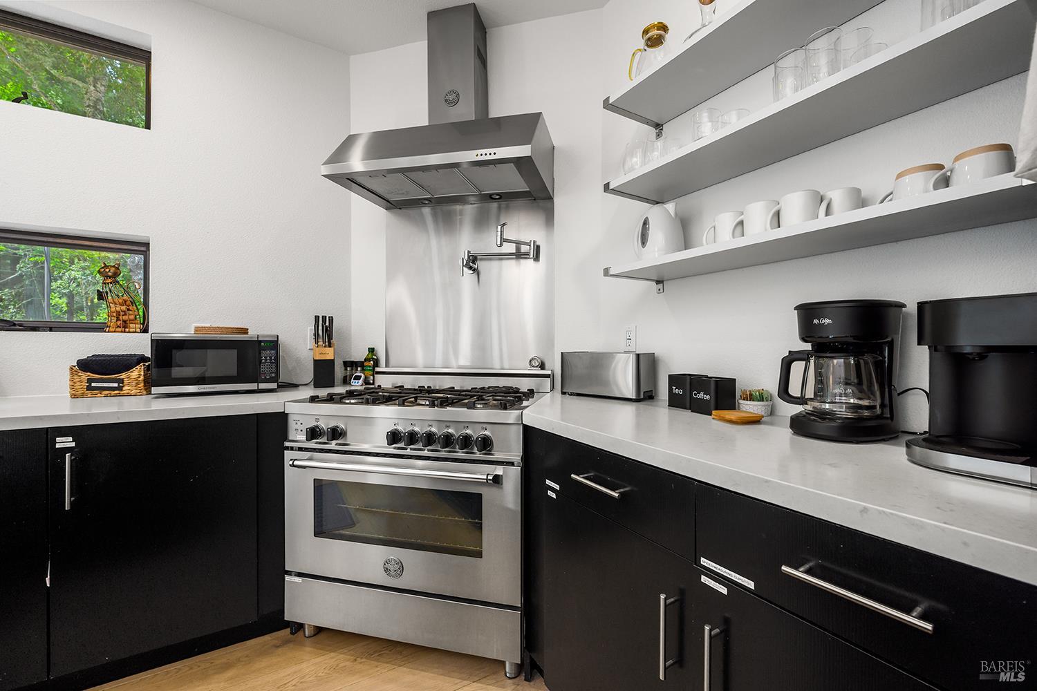 2563 Mill Creek Road Healdsburg, CA 95448 - Photo 17 of 42 a kitchen with stainless steel appliances a sink a stove and cabinets
