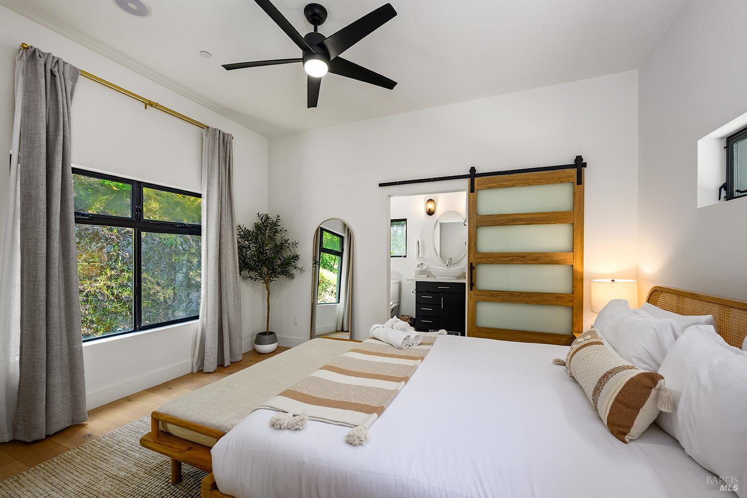 2563 Mill Creek Road Healdsburg, CA 95448 - Photo 20 of 42 a bedroom with a bed and a large window