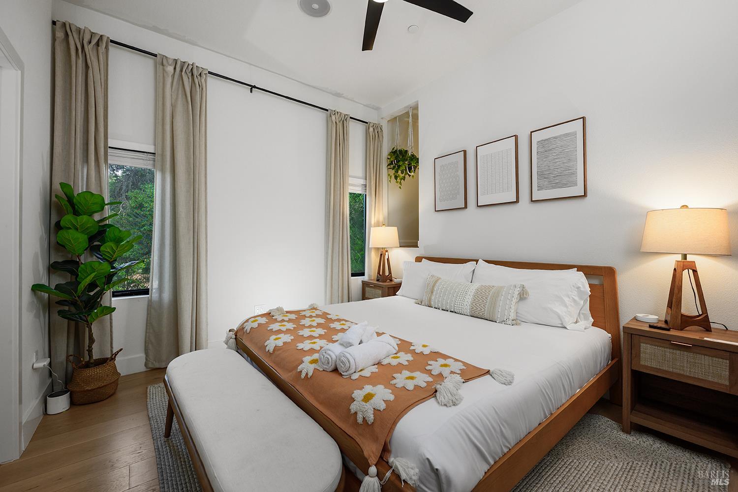 2563 Mill Creek Road Healdsburg, CA 95448 - Photo 23 of 42 a bedroom with a bed and a potted plant on the dresser