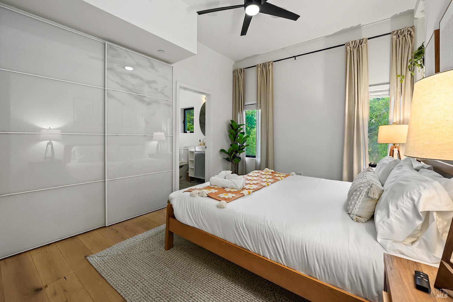 2563 Mill Creek Road Healdsburg, CA 95448 - Photo 24 of 42 a bedroom with a bed and wooden floor