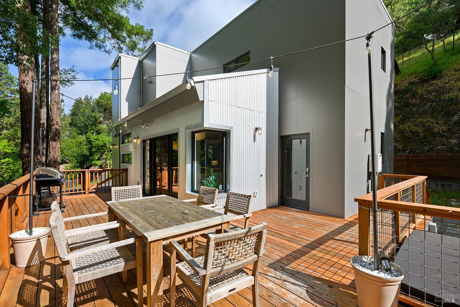 2563 Mill Creek Road Healdsburg, CA 95448 - Photo 27 of 42 a view of a patio with table and chairs with wooden floor and fence