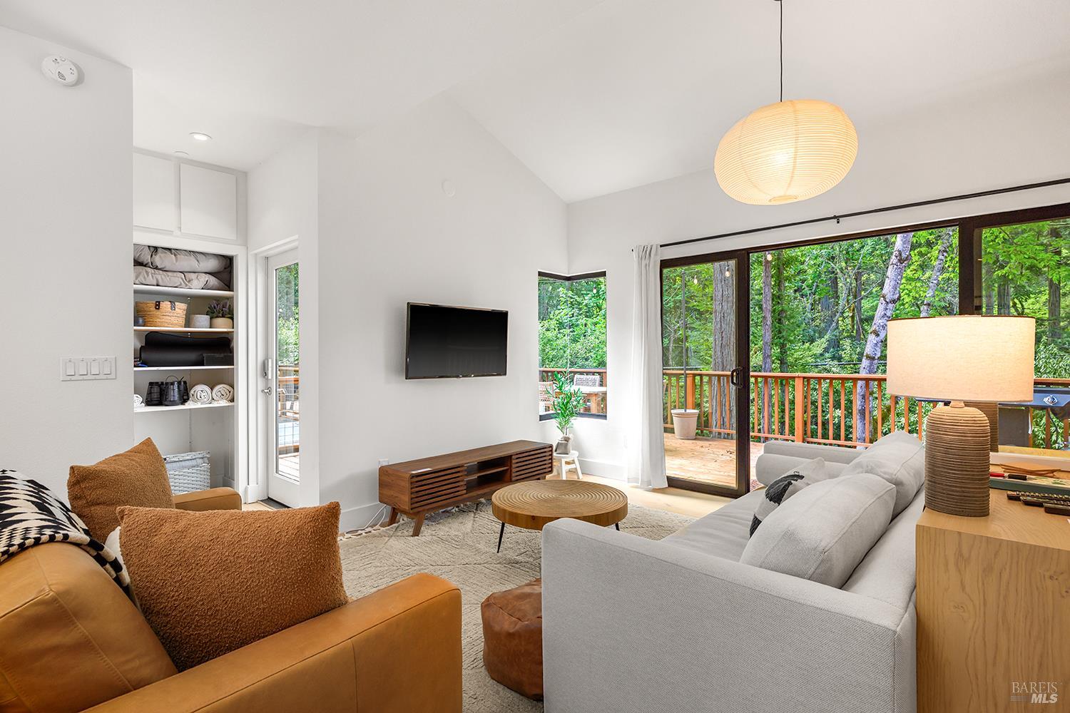 2563 Mill Creek Road Healdsburg, CA 95448 - Photo 5 of 42 a living room with furniture a large window and a flat screen tv