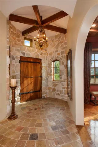 a view of a terrace with lawn chairs and a fire pit