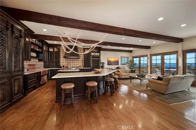 a view of a patio with couches and table and chairs and potted plants