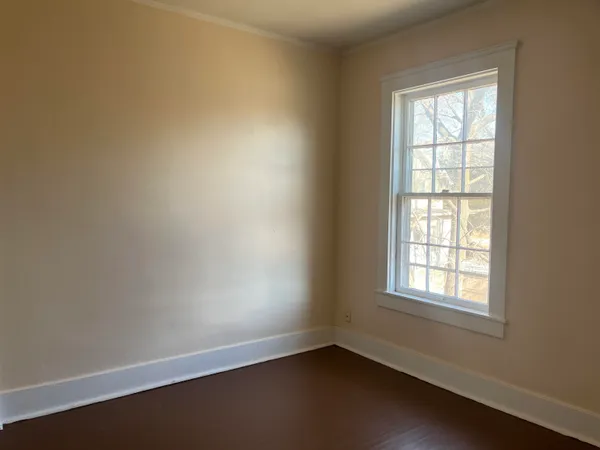 an empty room with wooden floor