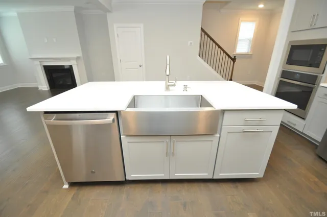 an empty room with windows and fireplace