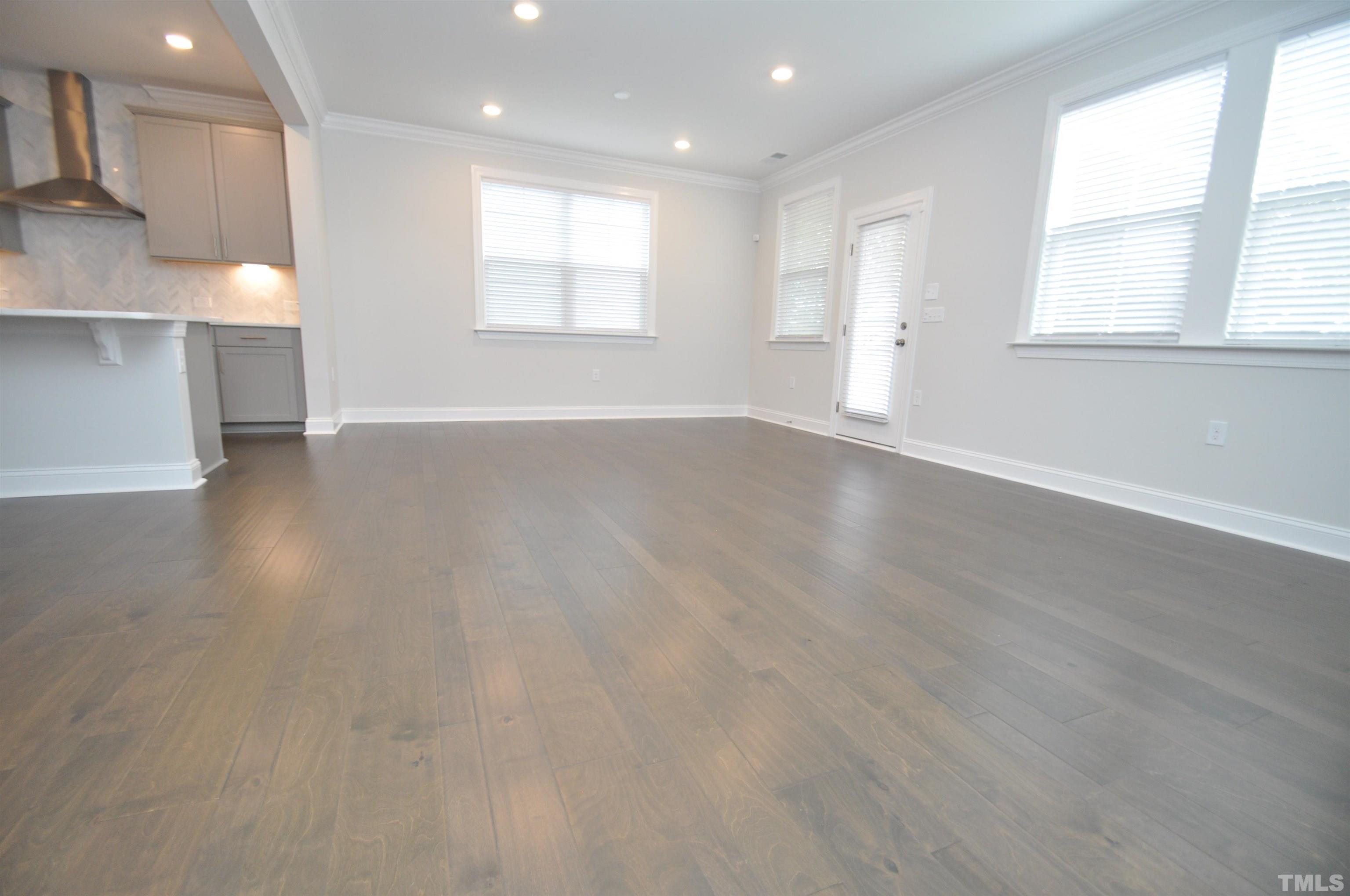 2949 Rise And Shine Road Apex, NC 27523 - Photo 14 of 49 an empty room with wooden floor and windows