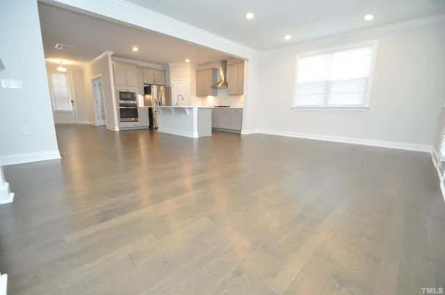 a view of hallway with wooden floor