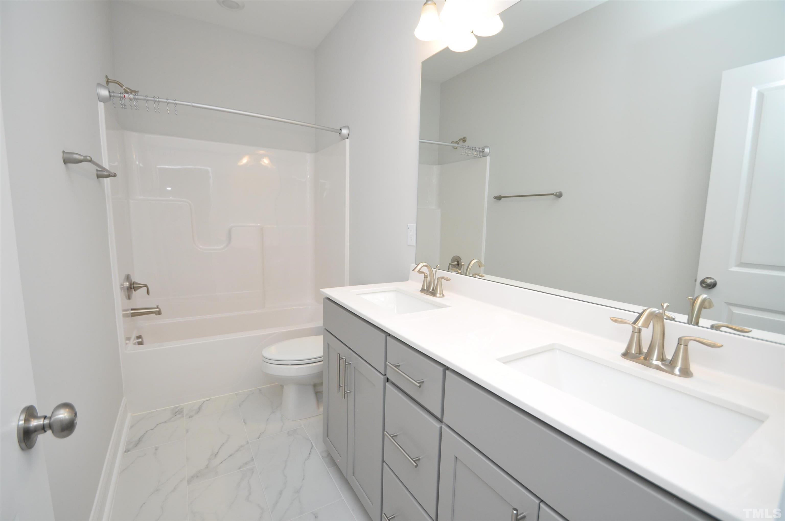 2949 Rise And Shine Road Apex, NC 27523 - Photo 21 of 49 a bathroom with a sink a toilet and shower