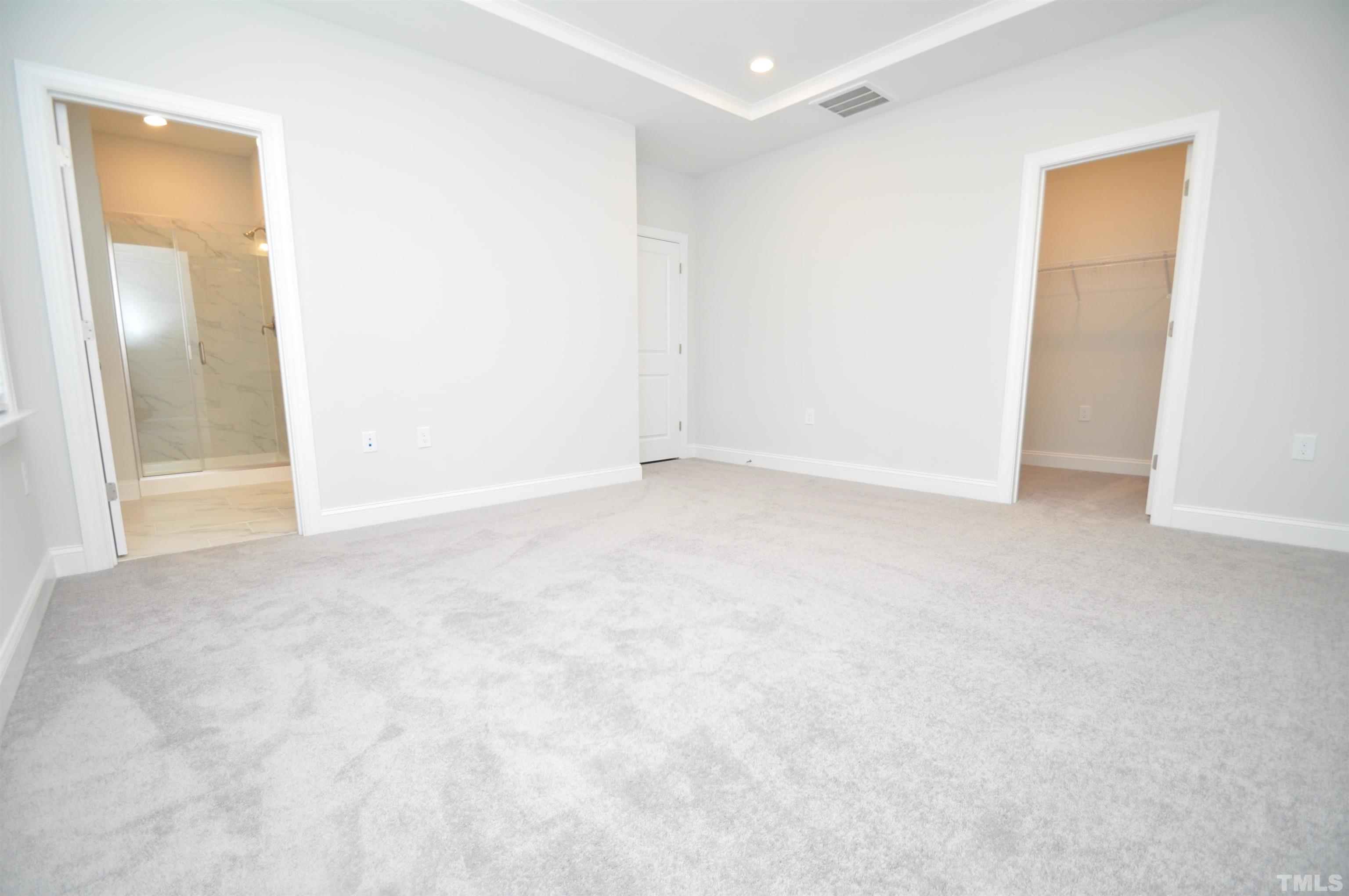 2949 Rise And Shine Road Apex, NC 27523 - Photo 27 of 49 an empty room with mirror in closet