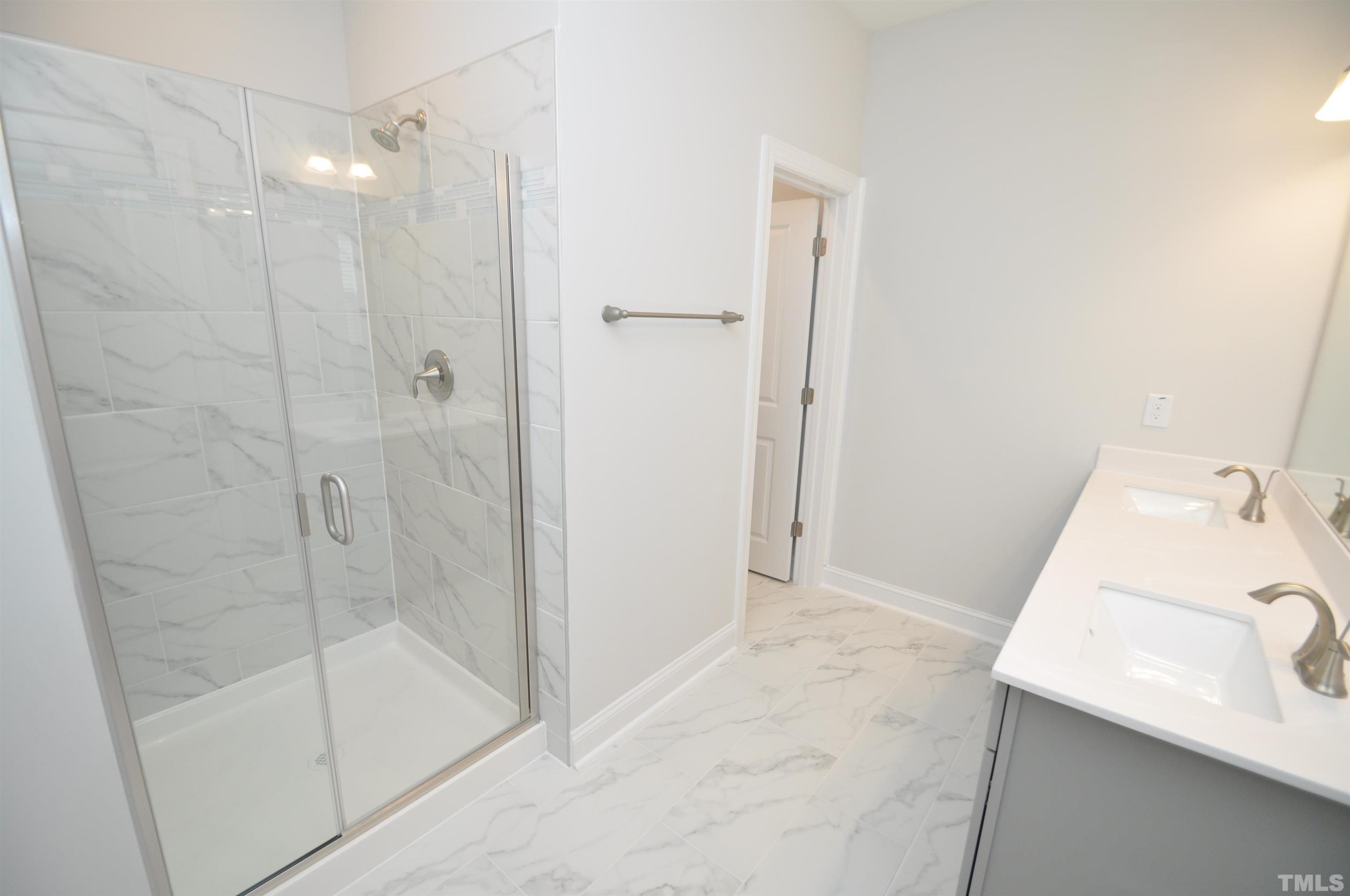 2949 Rise And Shine Road Apex, NC 27523 - Photo 30 of 49 a bathroom with a sink and a shower