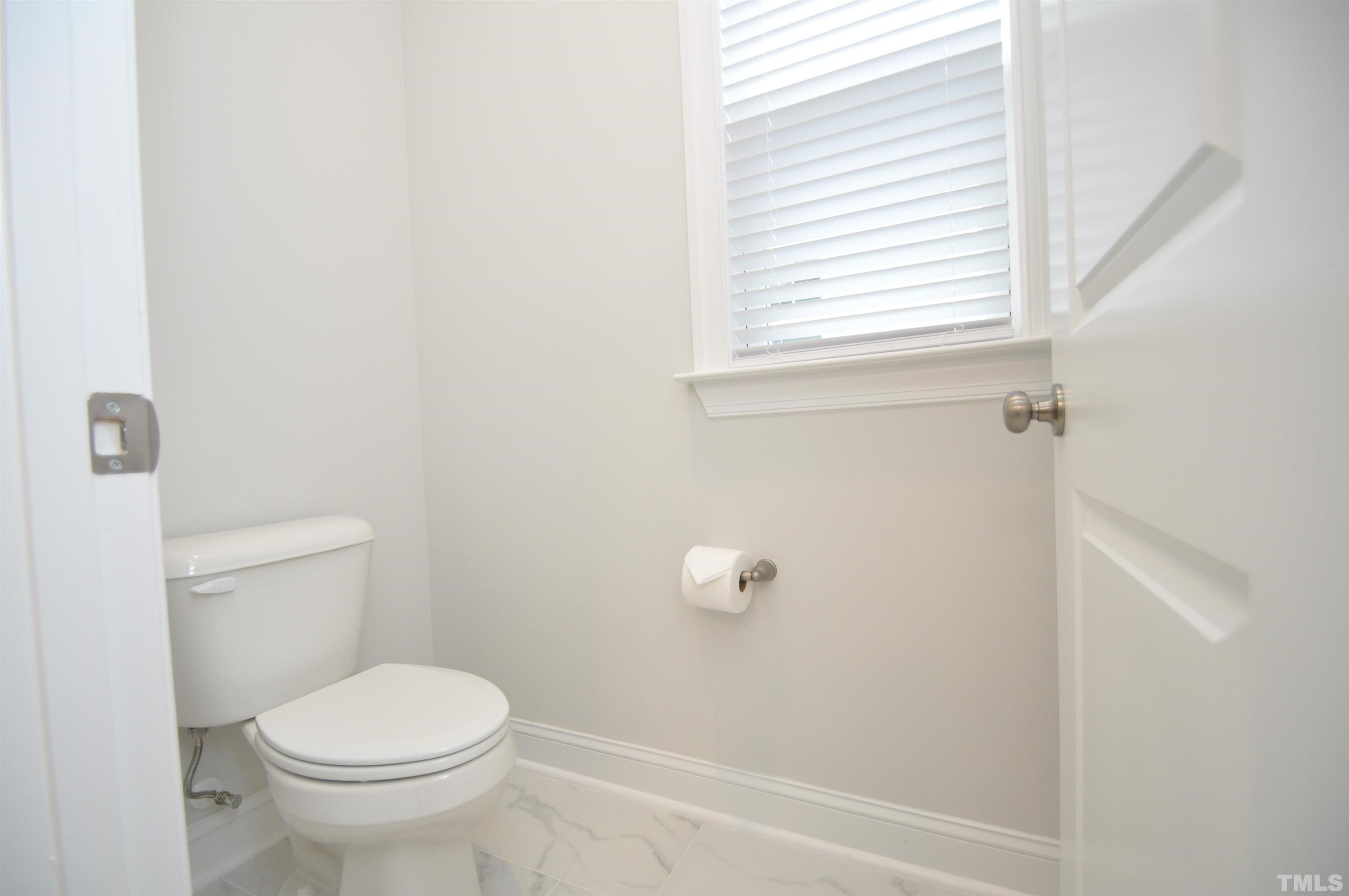 2949 Rise And Shine Road Apex, NC 27523 - Photo 33 of 49 a white toilet sitting next to a window