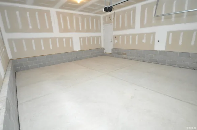 a view of house with garage and yard