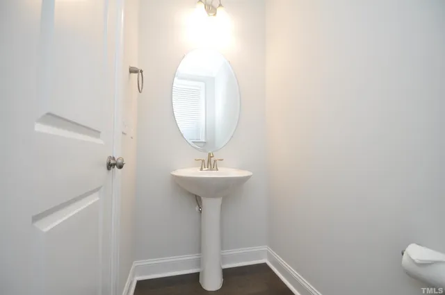 a bathroom with a sink a mirror and toilet