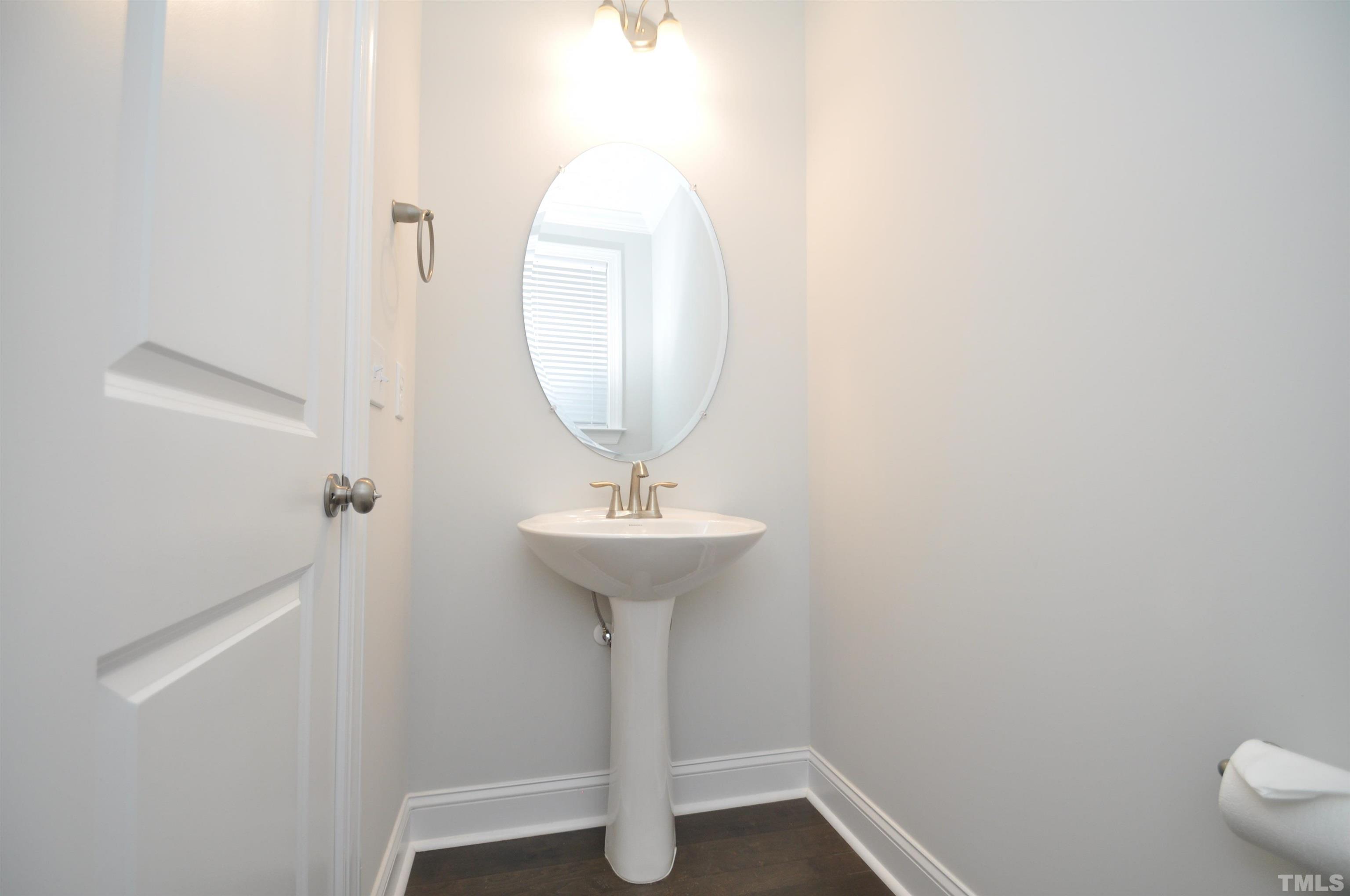 2949 Rise And Shine Road Apex, NC 27523 - Photo 4 of 49 a bathroom with a sink a mirror and toilet