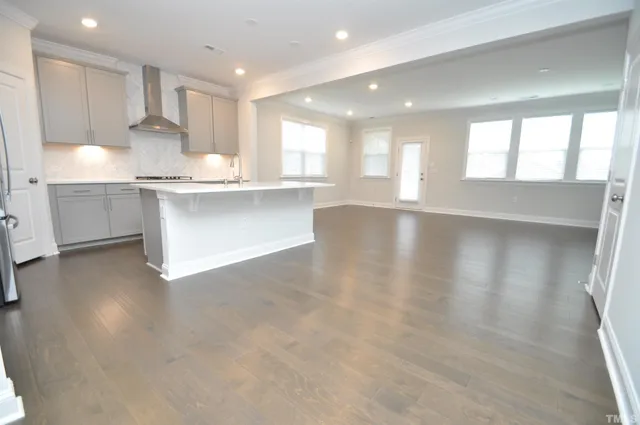 a kitchen with stainless steel appliances a microwave a sink and cabinets