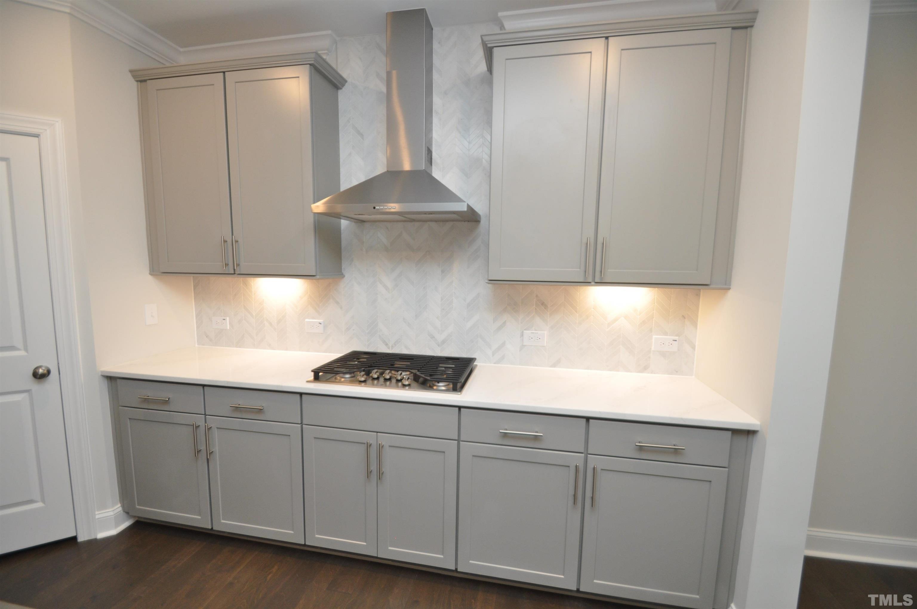 2949 Rise And Shine Road Apex, NC 27523 - Photo 9 of 49 a kitchen with white cabinets and white appliances