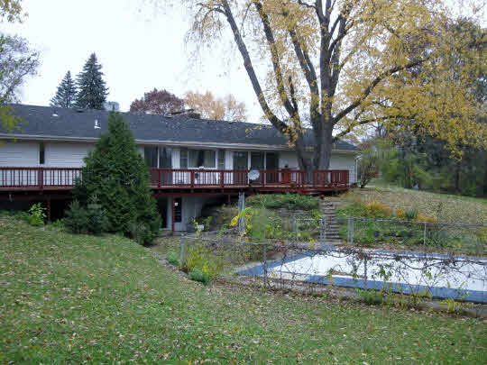3215 North View Road Rockford, IL 61107 - Photo 11 of 11 a front view of a house with a garden and trees