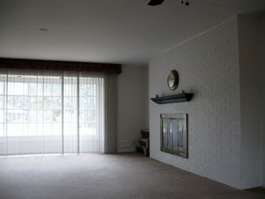 3215 North View Road Rockford, IL 61107 - Photo 4 of 11 a view of an empty room with a fireplace and a window