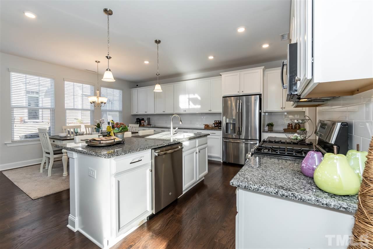 3 Moss Side Terrace Durham, NC 27703 - Photo 11 of 30 a kitchen with a sink a refrigerator and chairs