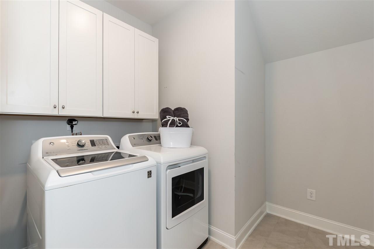3 Moss Side Terrace Durham, NC 27703 - Photo 15 of 30 a view of washer and dryer with kitchen in the background