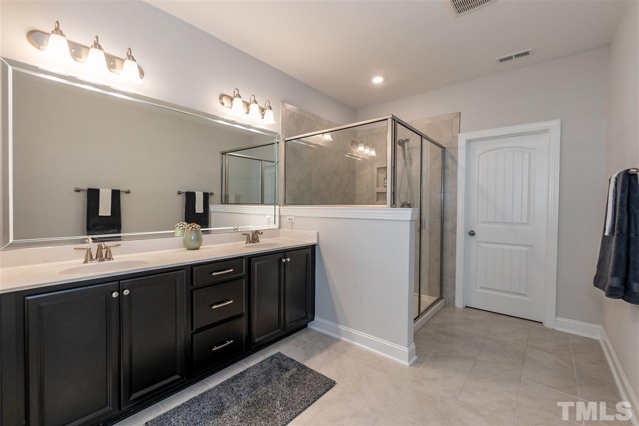3 Moss Side Terrace Durham, NC 27703 - Photo 19 of 30 a bathroom with a double vanity sink and mirror