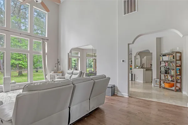 a living room with furniture and large windows