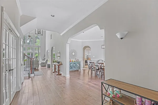 a living room with furniture a dining table and a large window