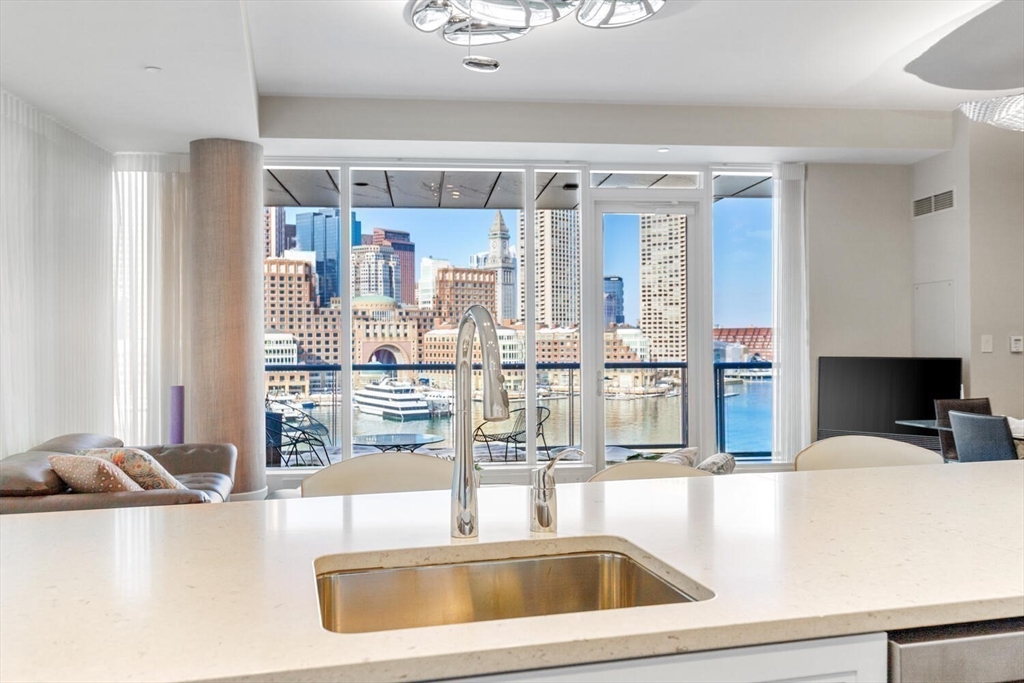 22 Liberty Drive, Unit 7M Boston, MA 02210 - Photo 2 of 42 a kitchen with a sink a counter top space and living room view
