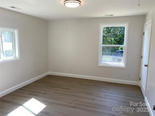 a bathroom with a sink mirror vanity and toilet