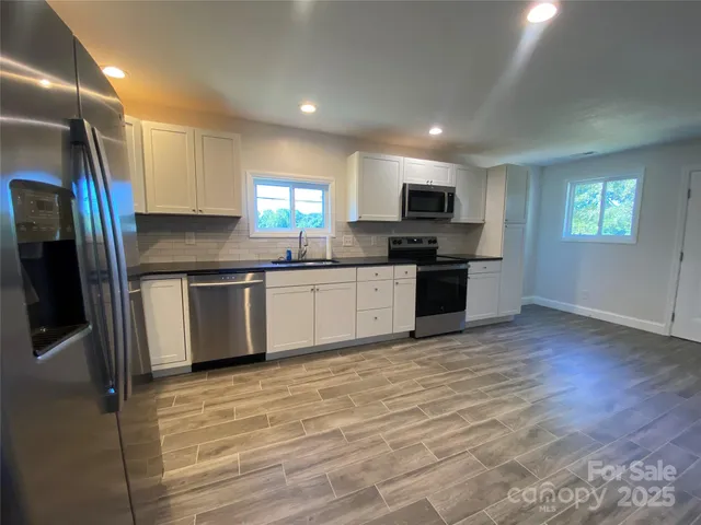 a view of hallway with wooden floor