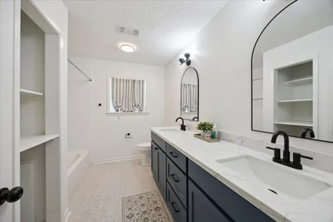 a bathroom with 2 sink and a mirror