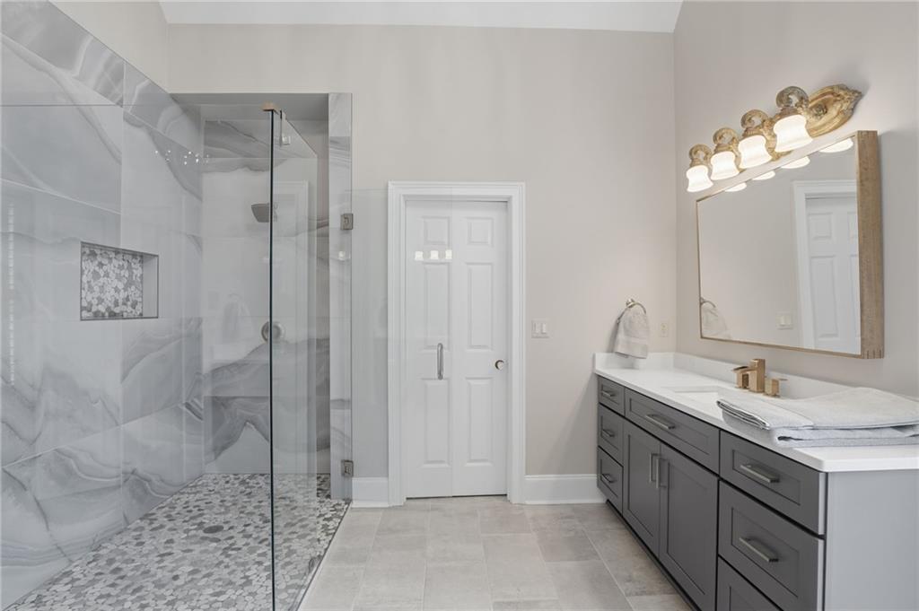 2950 Callie Still Road Lawrenceville, GA 30045 - Photo 27 of 77 a spacious bathroom with a double vanity sink mirror and shower