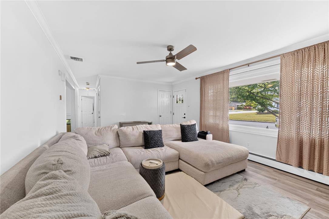 7290 Heather Road Macungie, PA 18062 - Photo 10 of 39 Relax in this comfortable living space, featuring a modern ceiling fan and rich wood flooring.