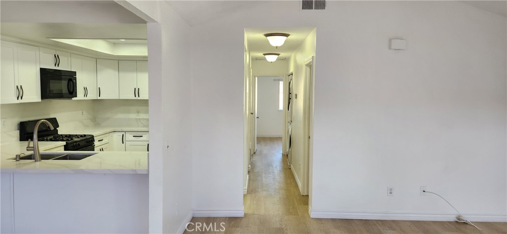 713 Walnut Drive Lake Elsinore, CA 92530 - Photo 12 of 28 a view of a kitchen from the hallway
